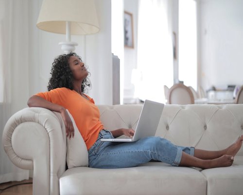 Woman sitting comfortably on a sofa relaxing